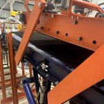bag flattener conveyor uses upper and lower belts to compress filled bags