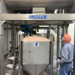 Blended seasoning mix being loaded into stainless steel IBC
