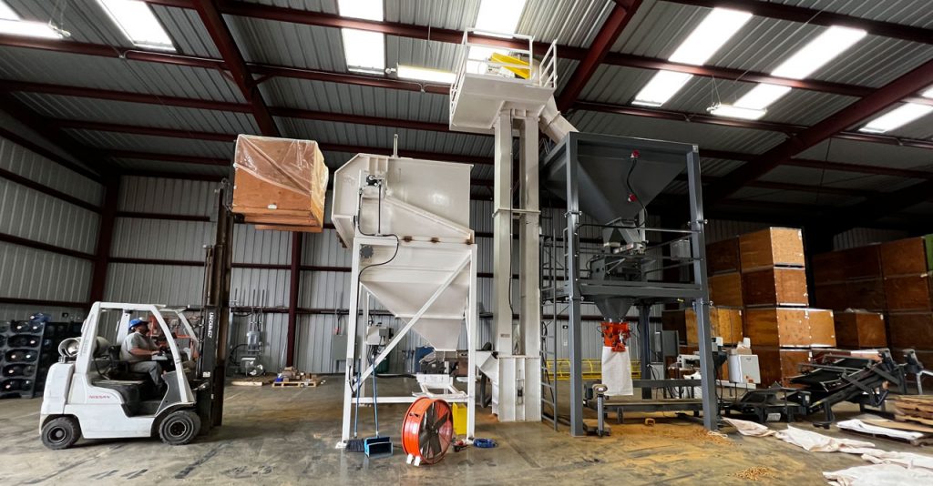 emptying bulk container with nuts into nut bagging system