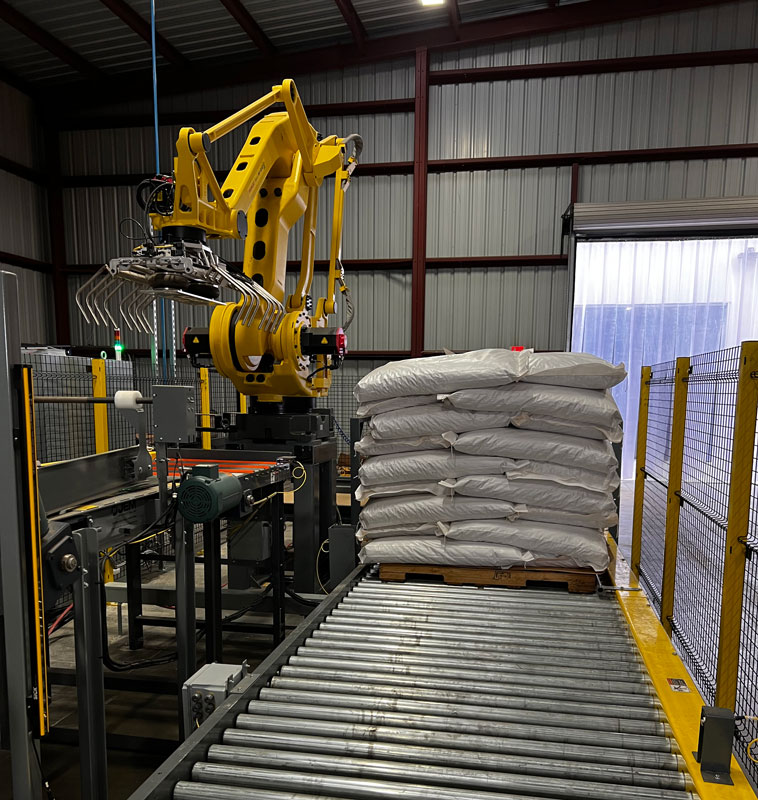 Robot stack zone conveyor and filled pallet takeaway conveyor
