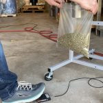 Press foot pedal to discharge pellets into bag