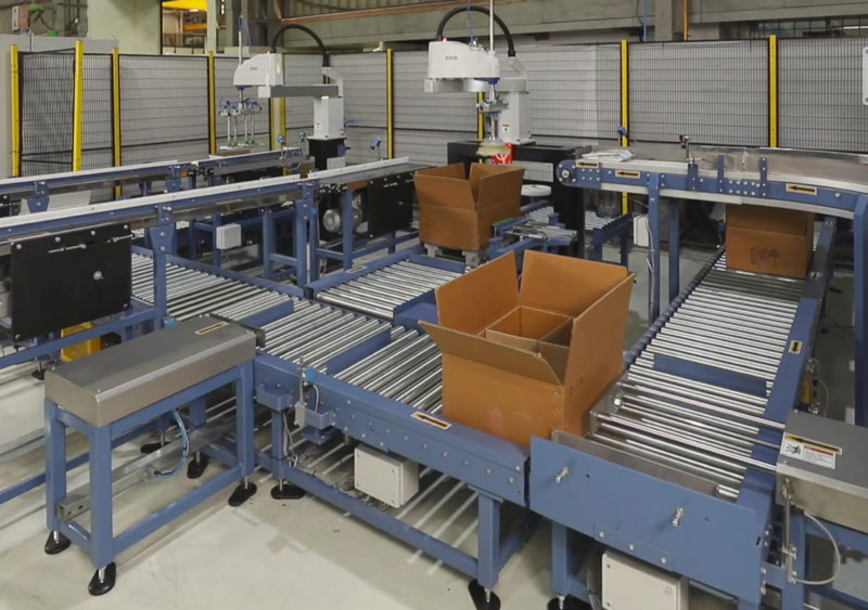 automatic box packing system places smaller bags and pouches into boxes
