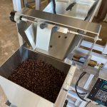 6 lbs of coffee beans in large weigh hopper on packaing machine