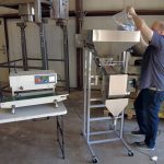 adding pinto beans to packaging machines hopper