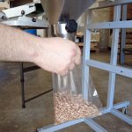 filling small bags with pinto beans