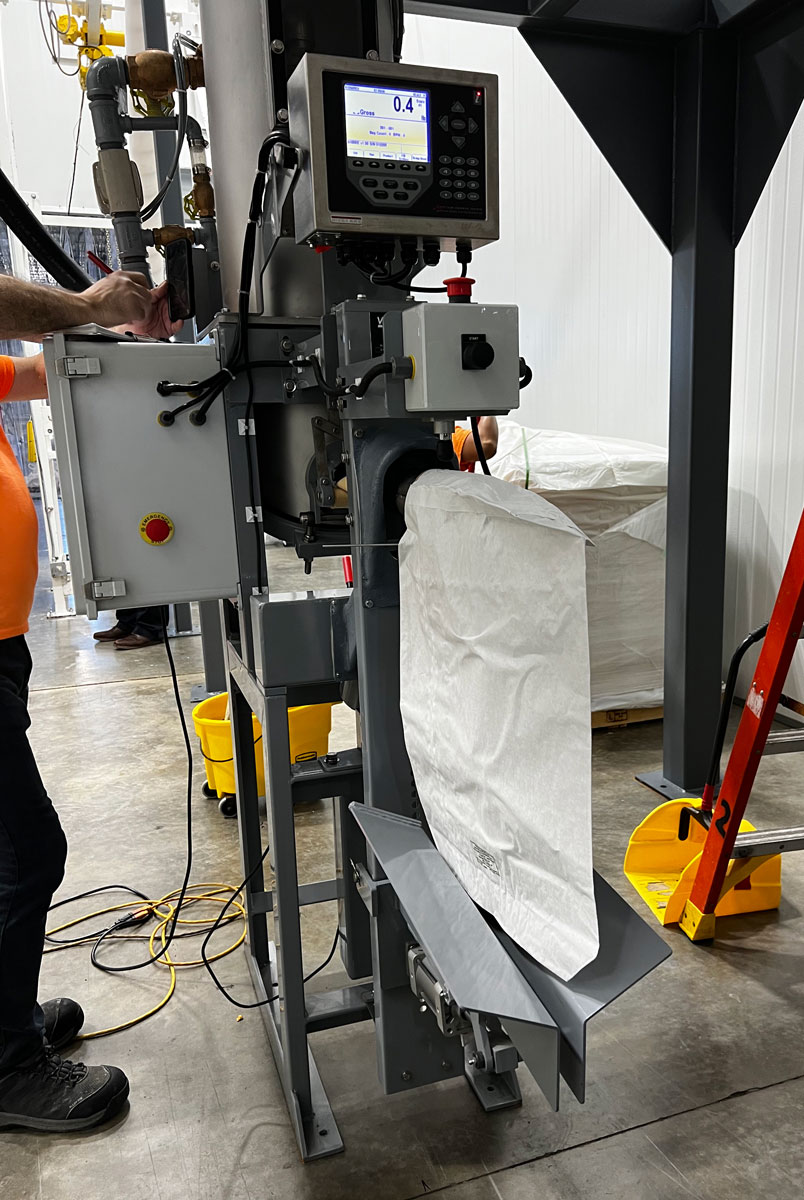 50 Lb. paper valve bag on air packer before a fill cycle starts