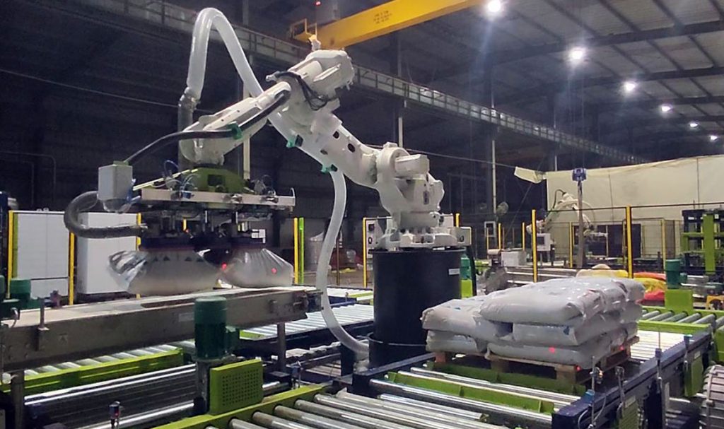 robotic depalletizer system placing bags on conveyor