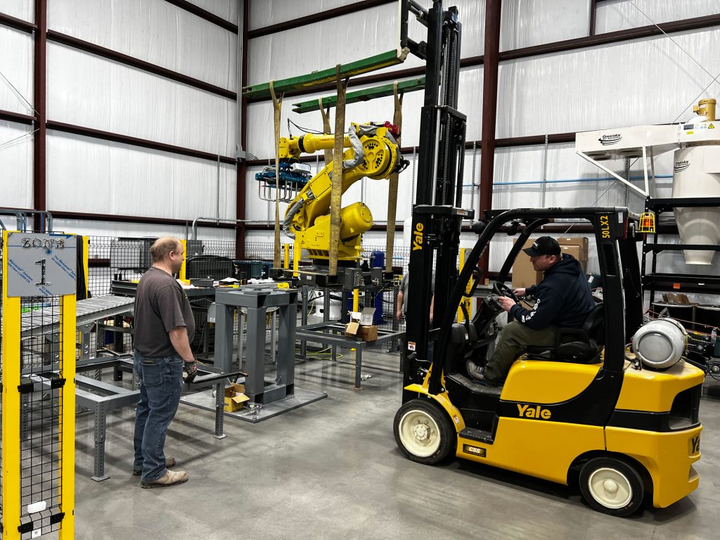 lowering bag palletizing robot onto base stacking zones located on each side