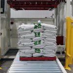 005-finished-pallet-with-stacked-bags-on-powered-roller-conveyor