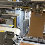 automatic bag placer for open top paper bags filled with glass beads