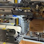 automatic bag placer for open top paper bags filled with seasoning