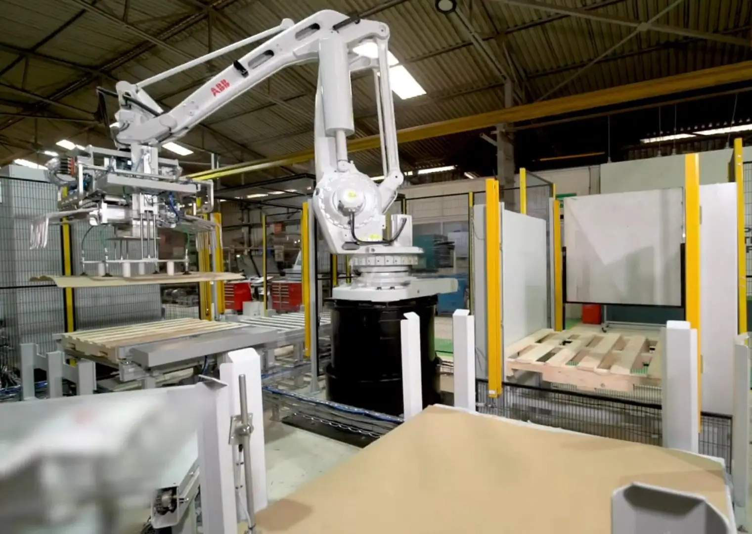 robot placing a cardboard slip sheet on a pallet