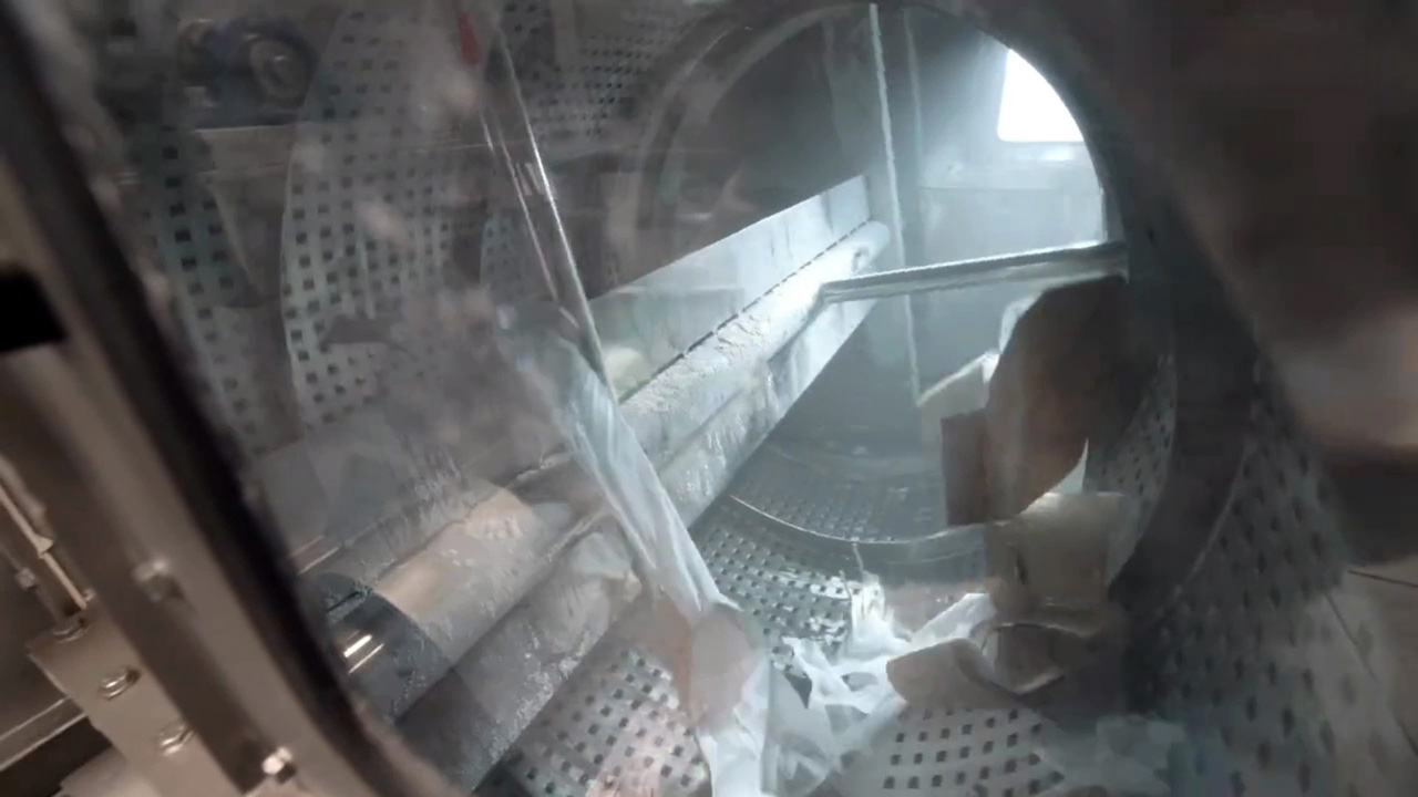 Sliced Bags Inside of Rotating Drum Trommel with Perforated Surface