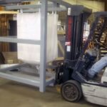 002 lifting frame containing bulk bag in spider frame assembly