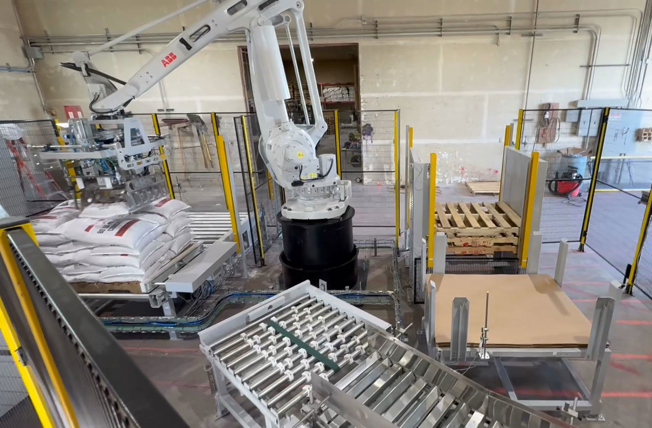 ABB robot dropping 80 lb bag of premix concrete onto pallet