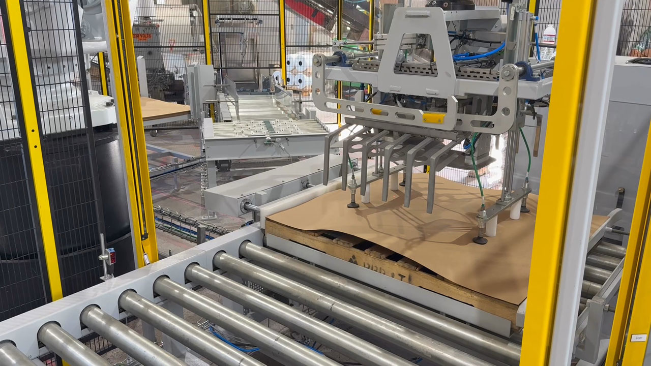 ABB robot placing a slip sheet using suction cups onto wooden pallet